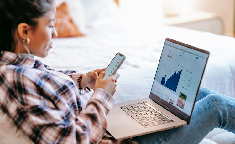 Jonge vrouw met smartphone en laptop